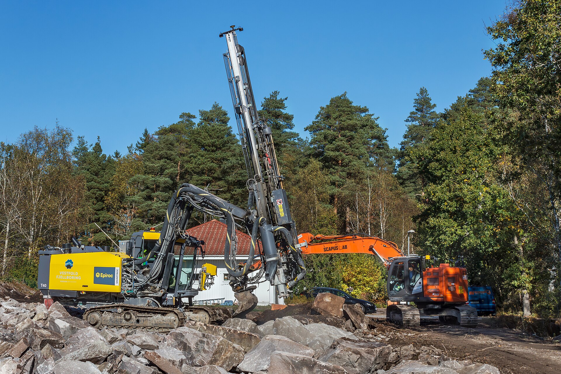 Heavy drilling rig and excavator on a construction project
